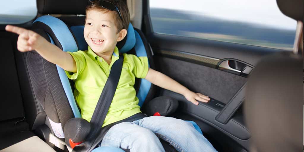 Child riding in a forward facing car seat